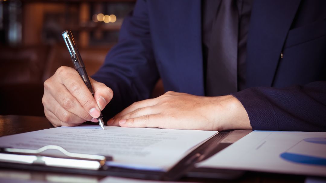 professional man signing paperwork