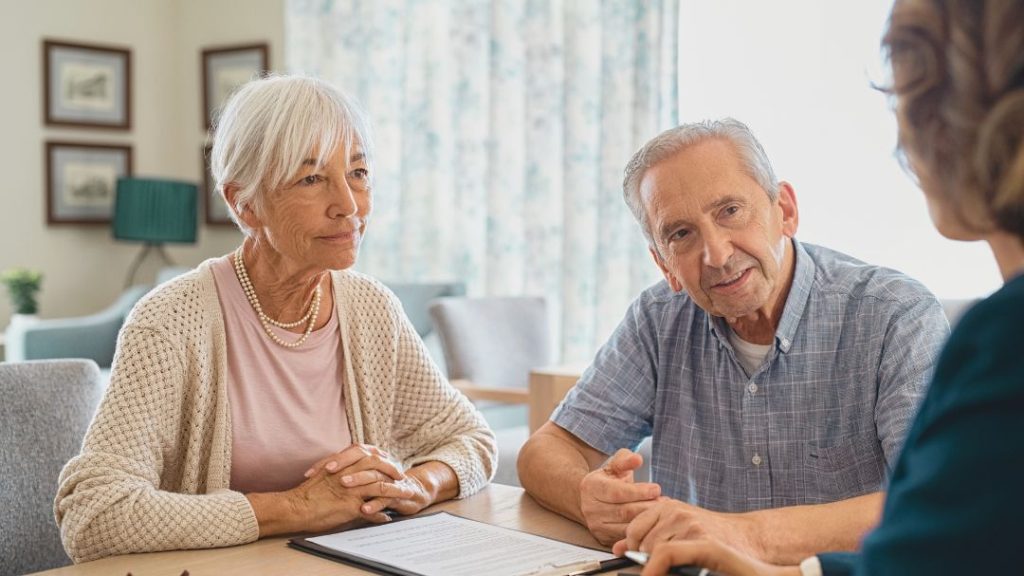 elderly couple meeting with professional