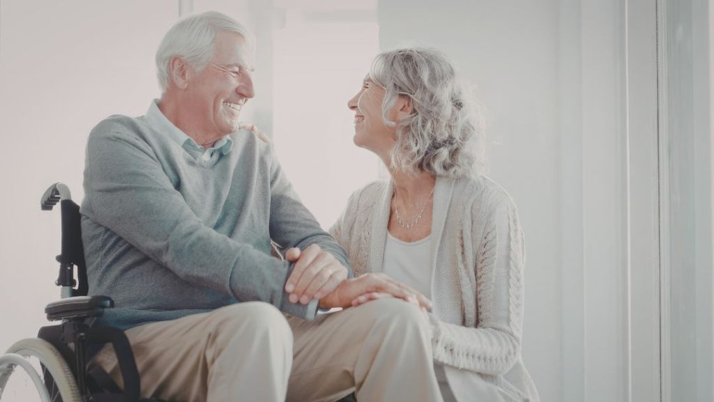 elderly couple smiling at each other
